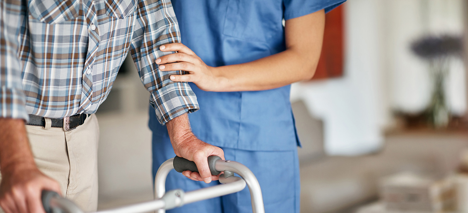 Home Caregiver Supporting Man with Walker