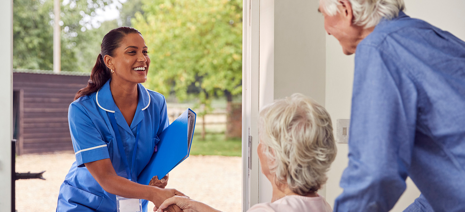 Caregiver with care plan arrives at seniors' home