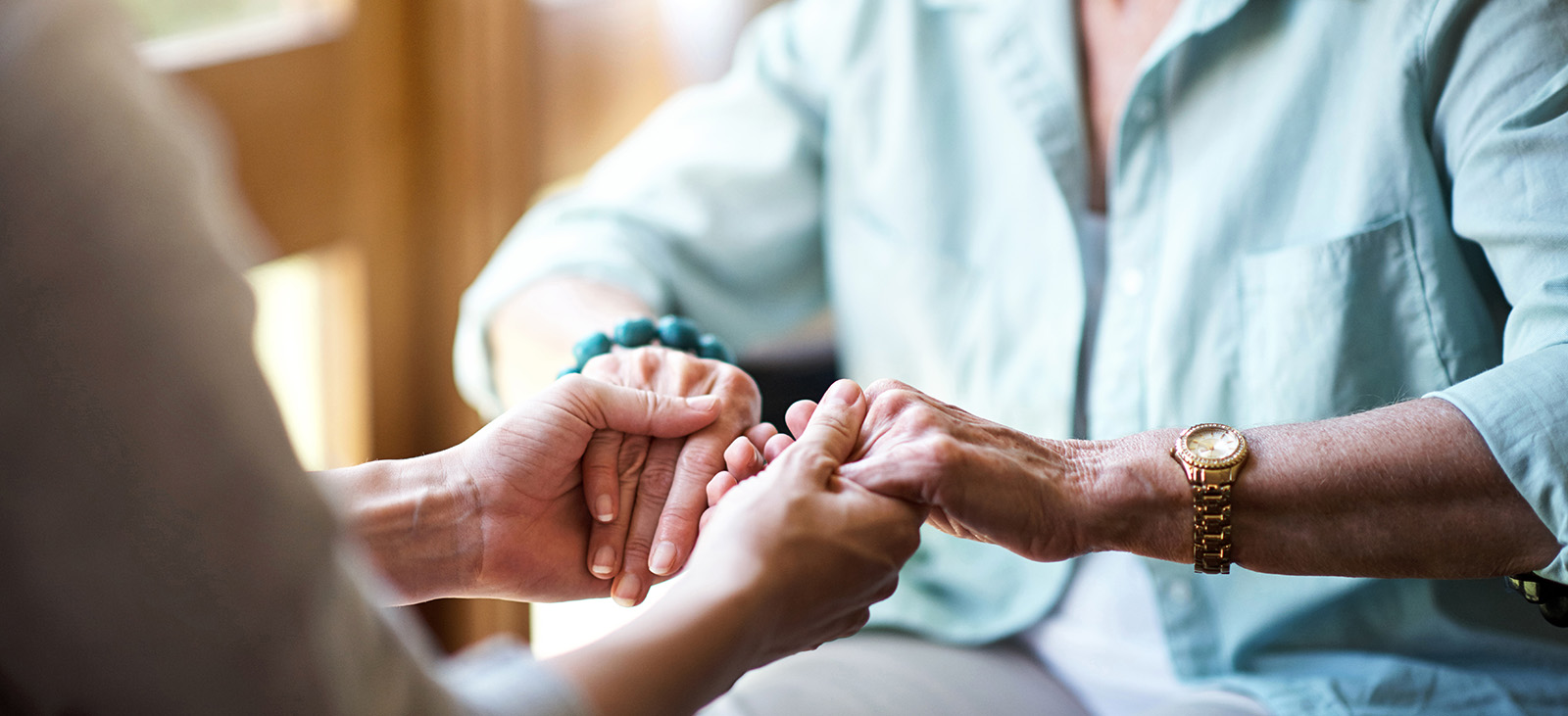 home care caregiver comforts senior